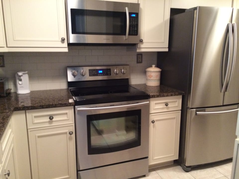 Kitchen including convection oven, microwave and large refrigerator
