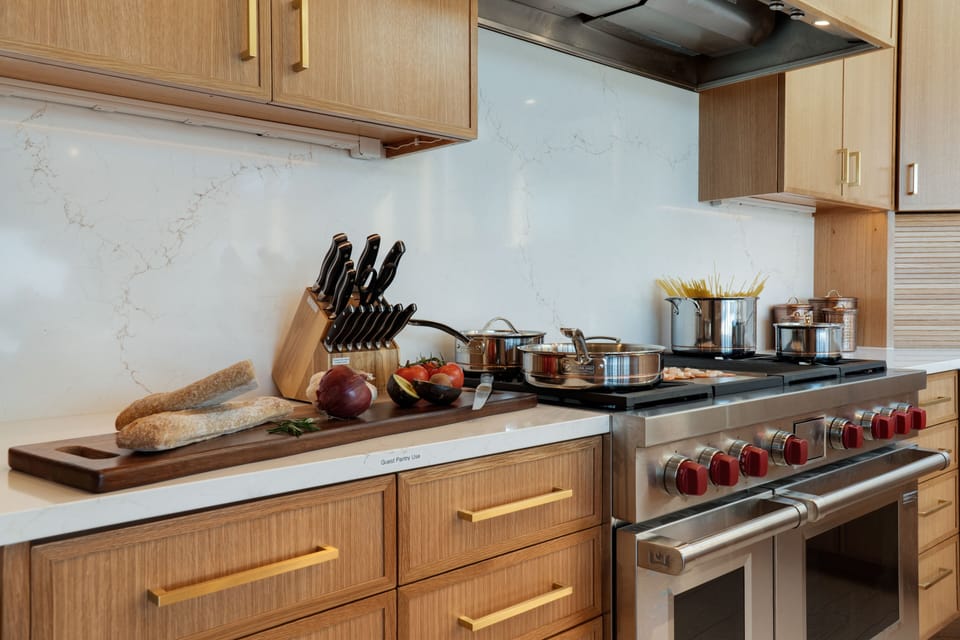 Wolf Range with 4 burners, a griddle, a grill and two electric ovens.  