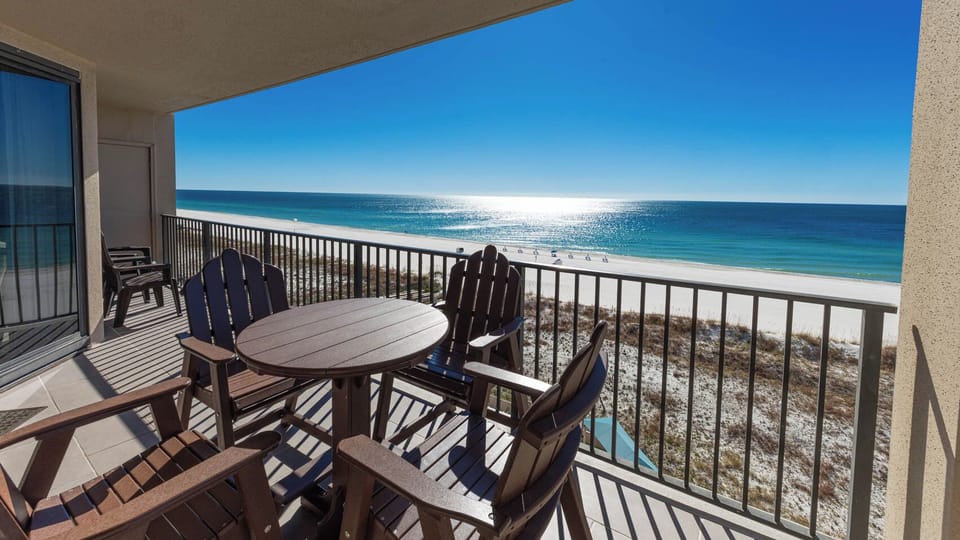 Relax at the outdoor table on the balcony, enjoying panoramic views of the sparkling water and shoreline
