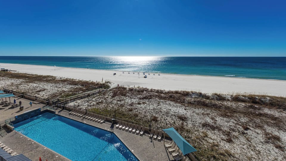 Take a refreshing dip in the pool while enjoying views of the shoreline and sparkling water just steps away