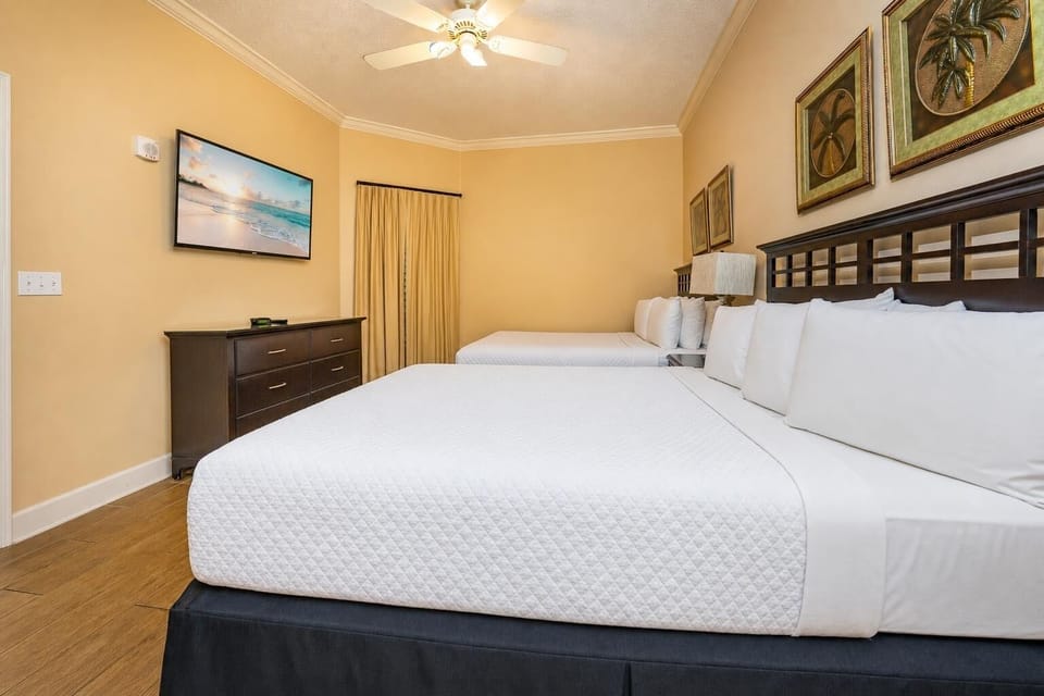 In the guest suite with two queens, unwind while enjoying your favorite shows on the flat screen TV