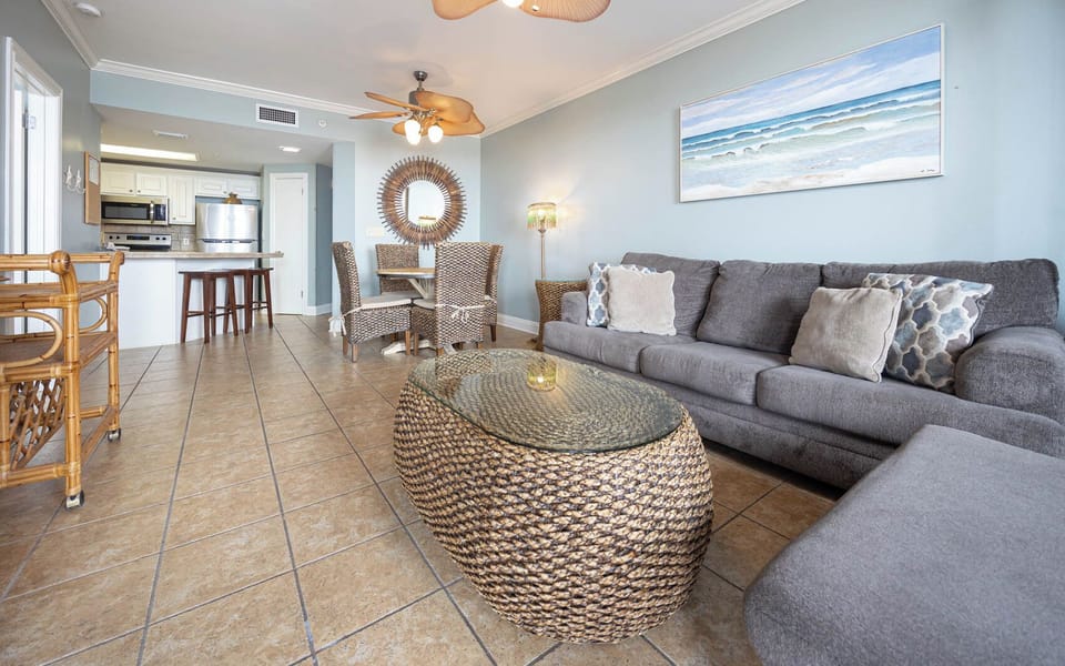 Unwind on the plush sofa with queen sleeper surrounded by coastal décor and stylish dining table with woven chairs