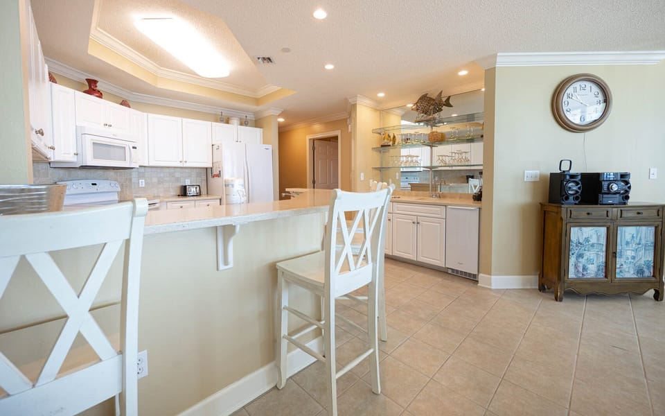 Enjoy morning coffee at the breakfast bar, surrounded by the inviting vibe of your coastal getaway