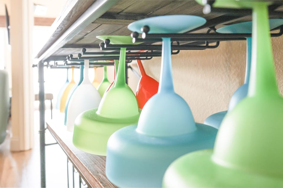 This kitchen features colorful glassware elegantly displayed, perfect for entertaining and enjoying beachfront views
