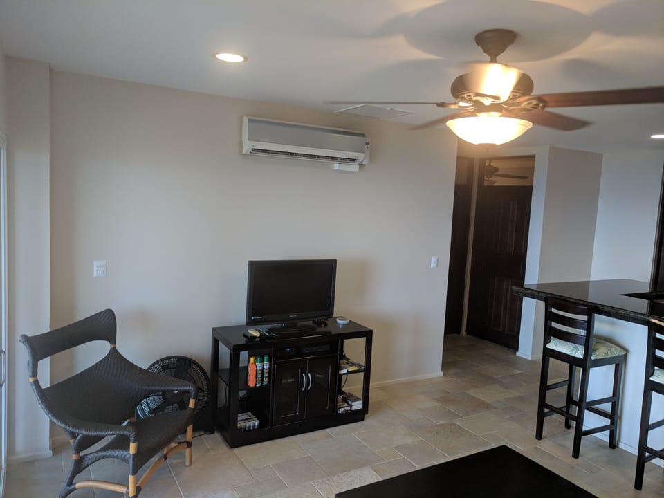 TV with cable in living room.  AC unit