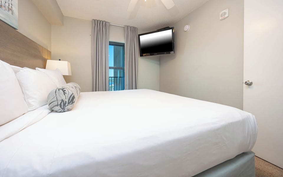 Rest in the comfortable bedroom featuring a plush king bed, soft lighting, and a TV for your entertainment