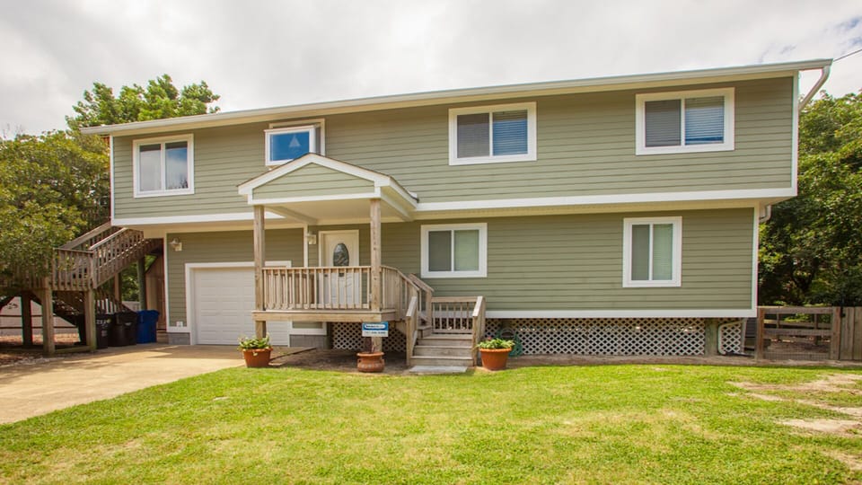 Front entrance with stairs to second level and screened porch.