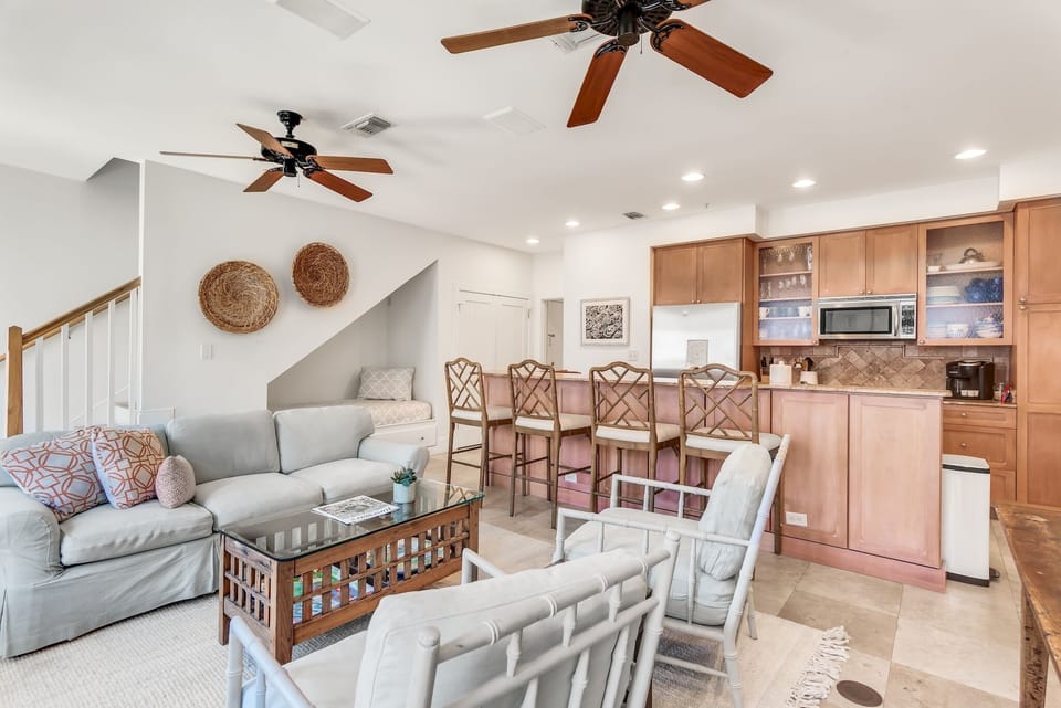 The lower level Features an open living-kitchen-dining area with access to the front staircase to Main St, a queen guest bedroom with full bathroom, and a built in twin bunk alcove in the living room.