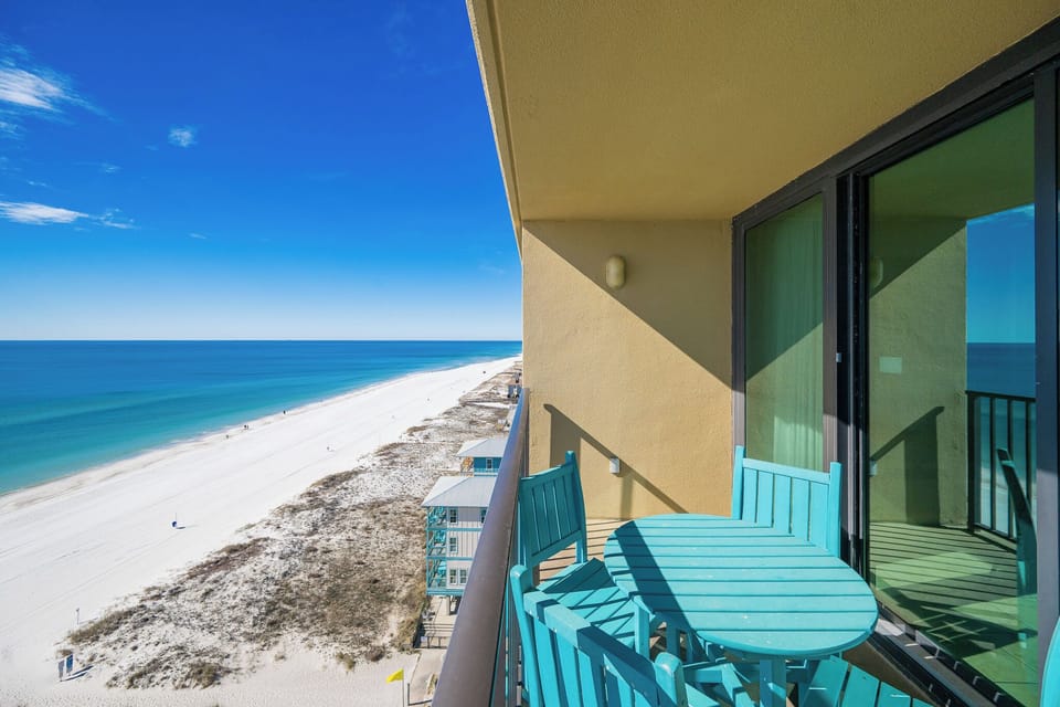 Your balcony invites you to savor the endless blue horizon and lively beach below
