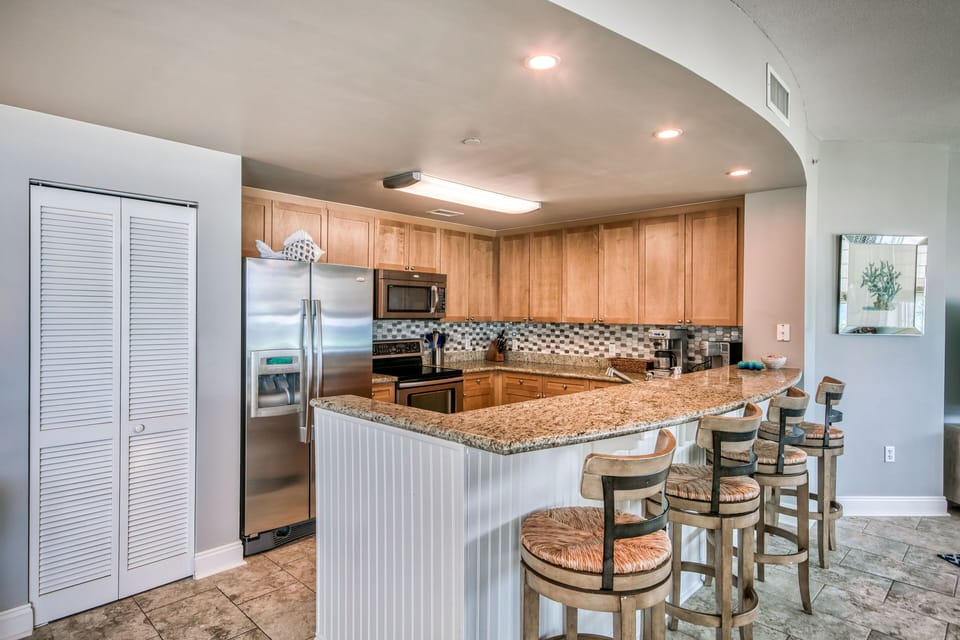 Fully equipped kitchen with stainless steel appliances and large pantry