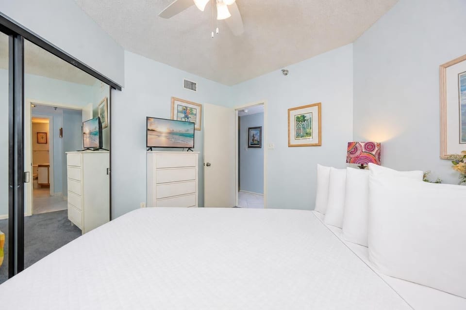 A queen bed in the guest suite invites you to relax while streaming your favorite coastal shows on TV