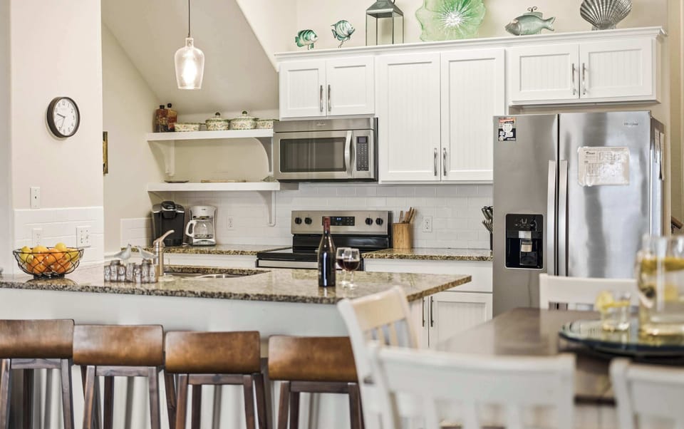 Kitchen — White Cabinets, Granite Counters, Subway Tile, Stainless Appliances & Glass Fish Decor