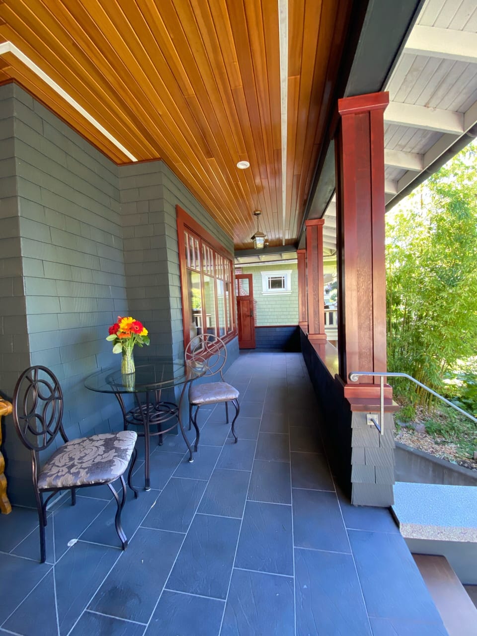 The porch overlooking the garden🪴  and the quiet street of Balaclava & 3rd Ave.