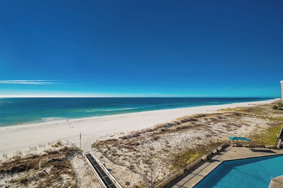 Gaze at the expansive water views while enjoying the inviting pool area just steps away from the beach