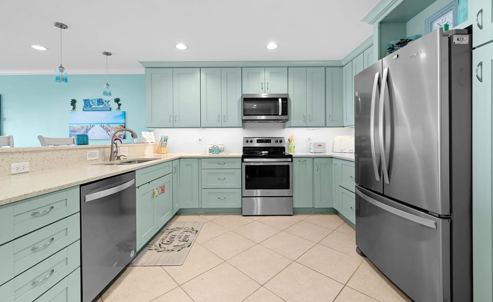 Kitchen — Mint Green Cabinets, Stainless Appliances, Quartz Counters & Blue Pendants