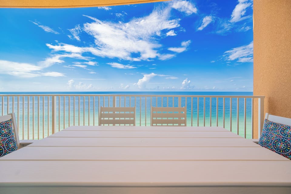 Dine at the outdoor table while enjoying expansive views of the tranquil waters and bright blue sky above