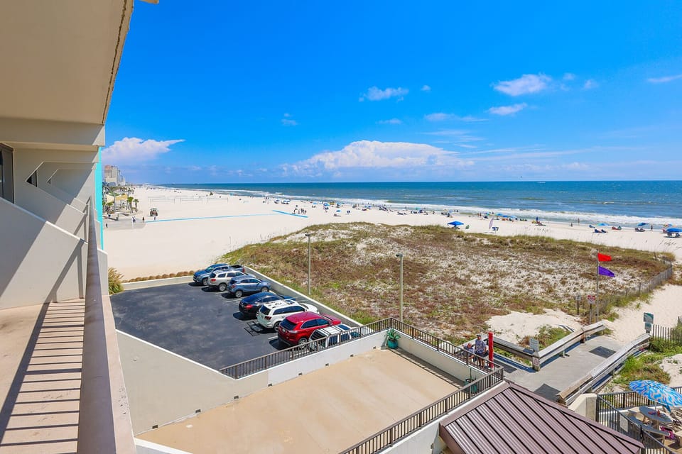 Enjoy stunning beachfront views from this inviting balcony, perfect for relaxation and soaking up the sun