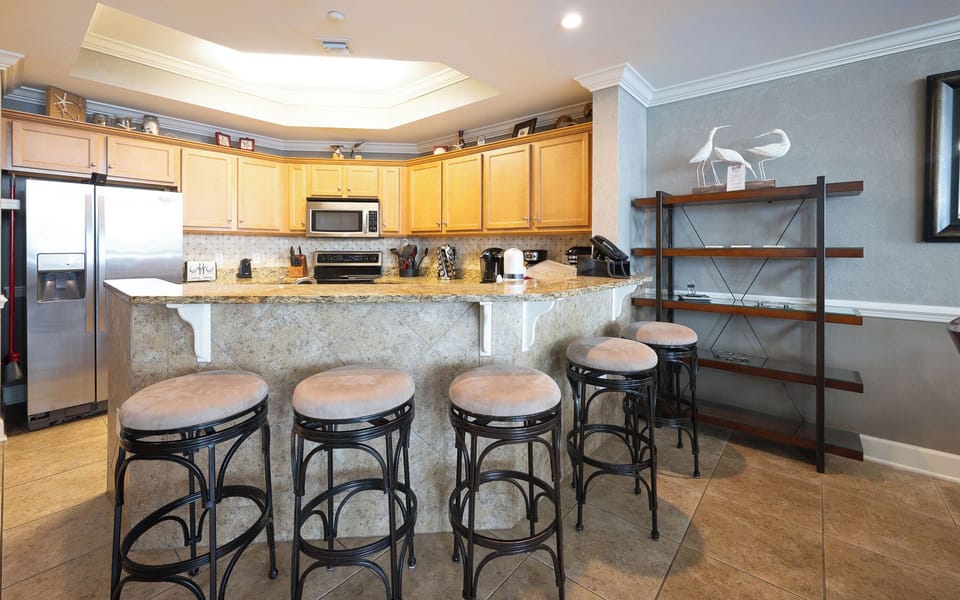Sip your favorite drink at the bar, as you unwind and soak in the inviting beach vibe of this spacious kitchen