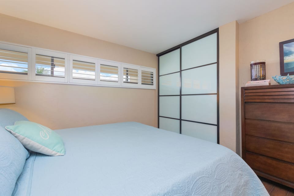Slip into crisp linens and enjoy your private retreat, featuring modern sliding closets and warm wood tones that create a peaceful sanctuary for your stay.