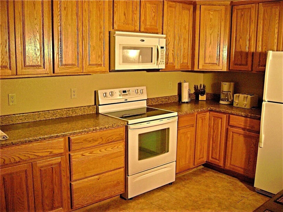 Fully equipped kitchen next to large capacity laundry room. Everything you need!