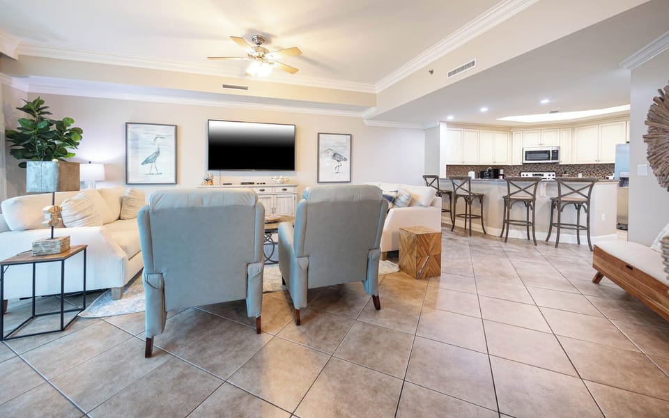Unwind in the family room while enjoying family movie nights together, surrounded by coastal decor