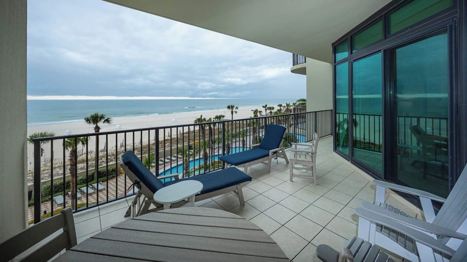 Relax on your balcony, soaking in the sights of the beach and enjoying the sparkling pool area