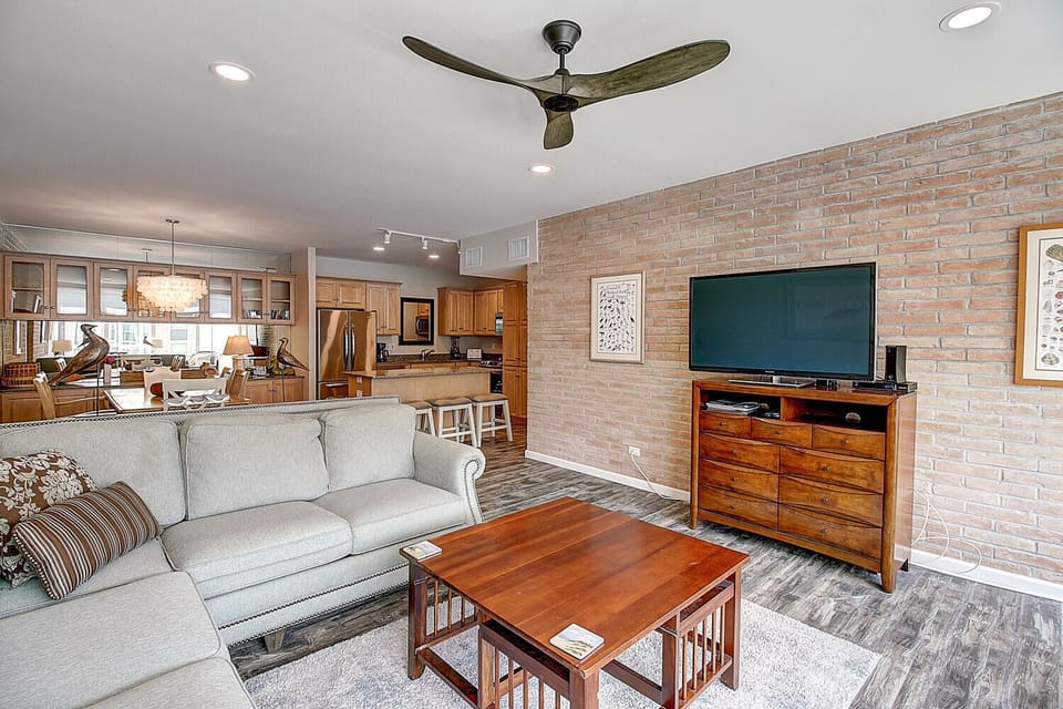 Relax in your stylish open-plan living space with exposed brick walls, modern amenities, and a fully equipped kitchen perfect for your stay.