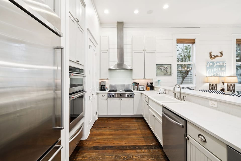 Your dream kitchen awaits with pristine white cabinets, marble countertops, and professional appliances ready for memorable meals.