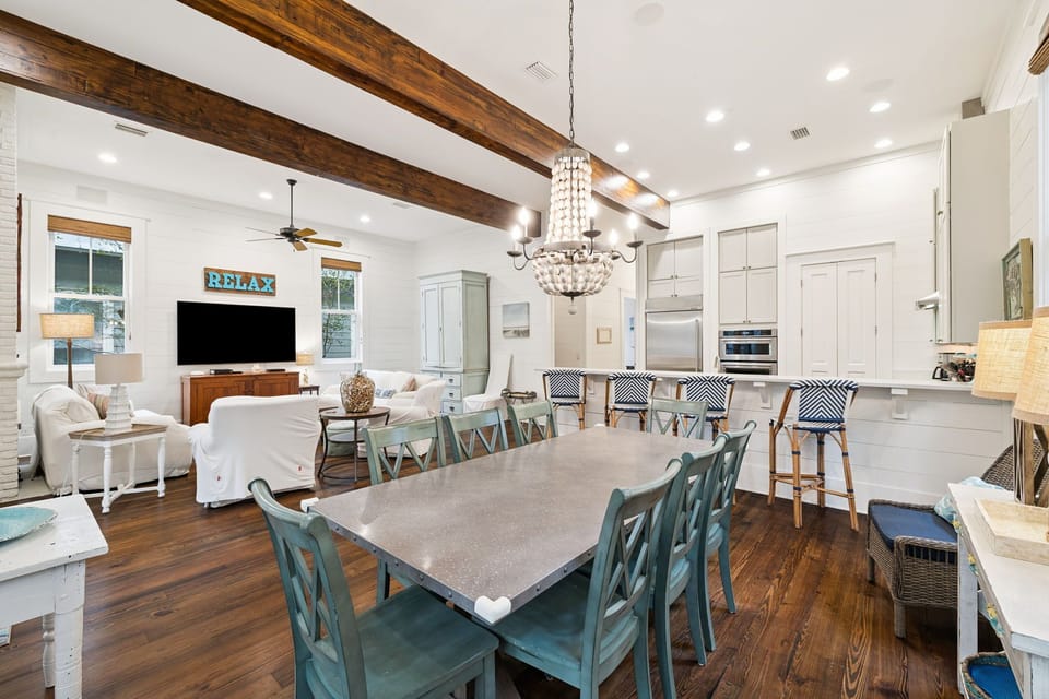 Gather your group around this stunning open-plan space where exposed beams meet modern elegance, perfect for cooking together and sharing meals.