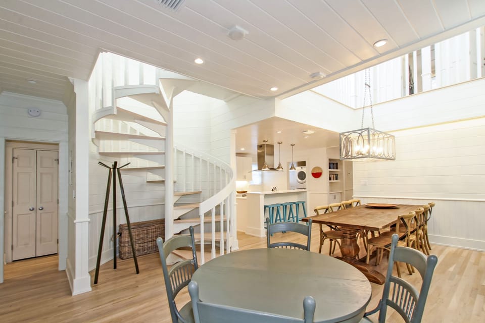 GAME TABLE AND CENTER SPIRAL STAIRCASE TO SECOND FLOOR