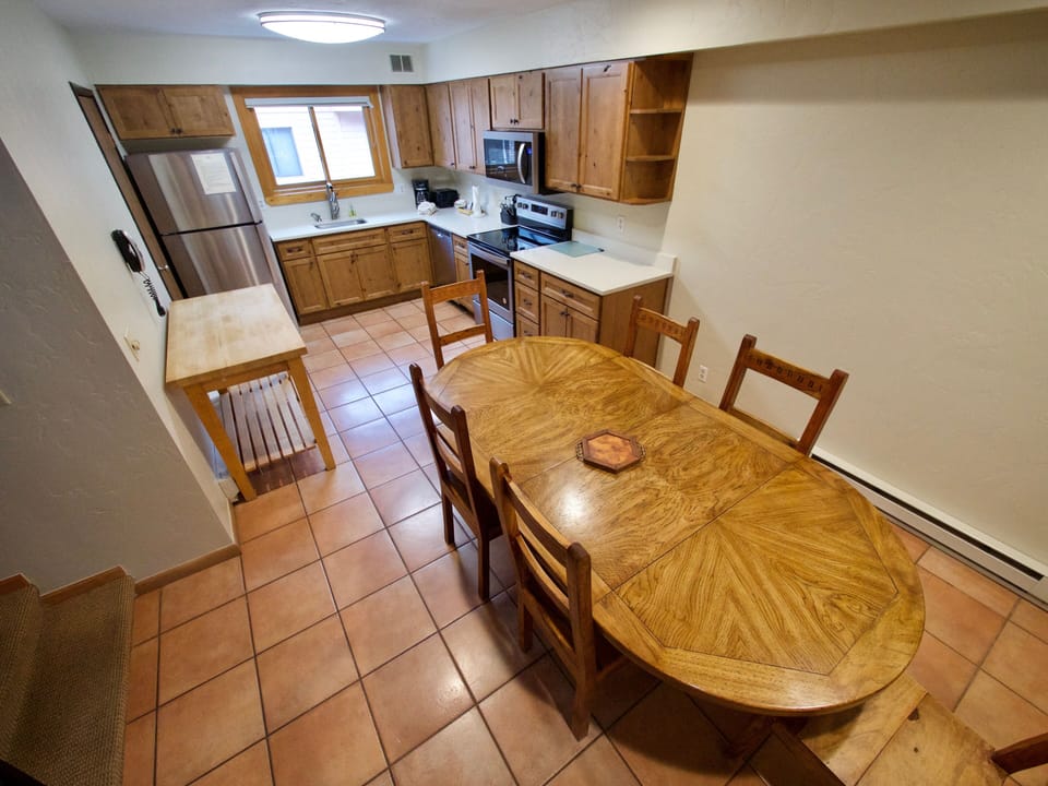 Dining Area and Kitchen - This fully equipped kitchen and dining room area is a great place for the entire party.