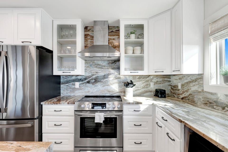 Featuring stainless appliances and stone counters
