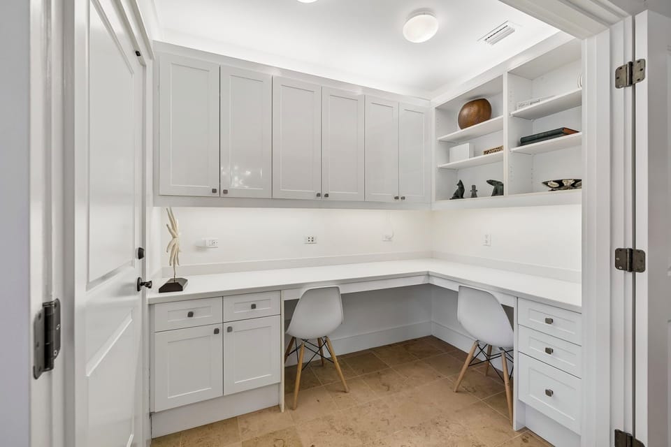 Work comfortably side by side or focus solo at this bright, built-in dual workspace, with ample storage and display shelving for your devices and personal items.