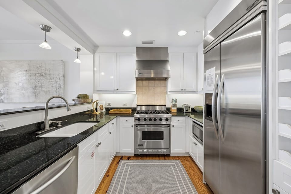 A chef's dream kitchen awaits you, with gleaming countertops, stainless steel appliances, and all the space you need to whip up anything from morning coffee to gourmet meals.