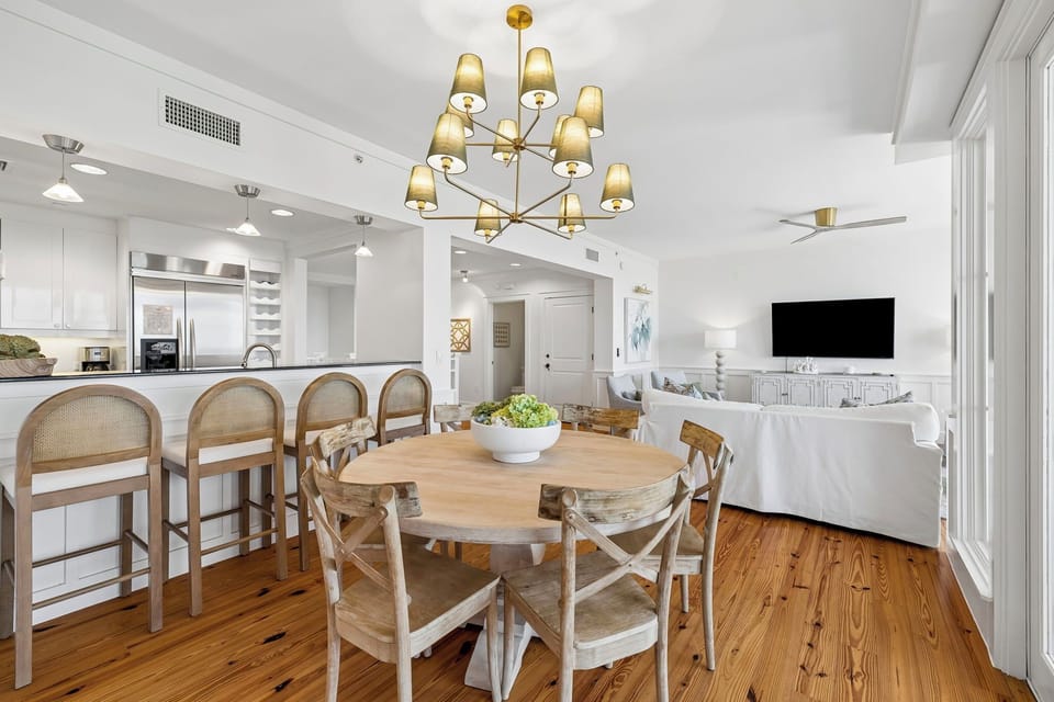 Gather around this beautiful round dining table, where meals turn into memories under the soft glow of a stunning chandelier. The open layout flows seamlessly into the kitchen and living area.