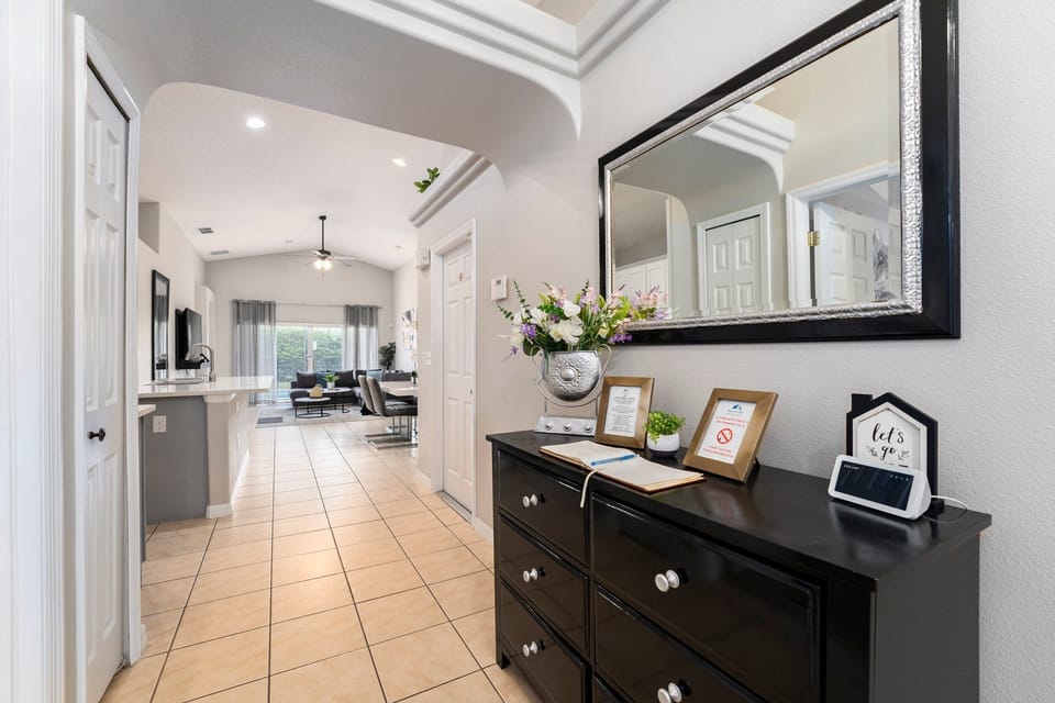 Front entry showing kitchen, dining and living rooms and pool access
