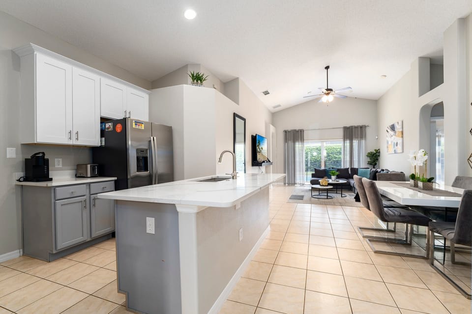 Kitchen nicely equipped for home cooking showing open floor plan