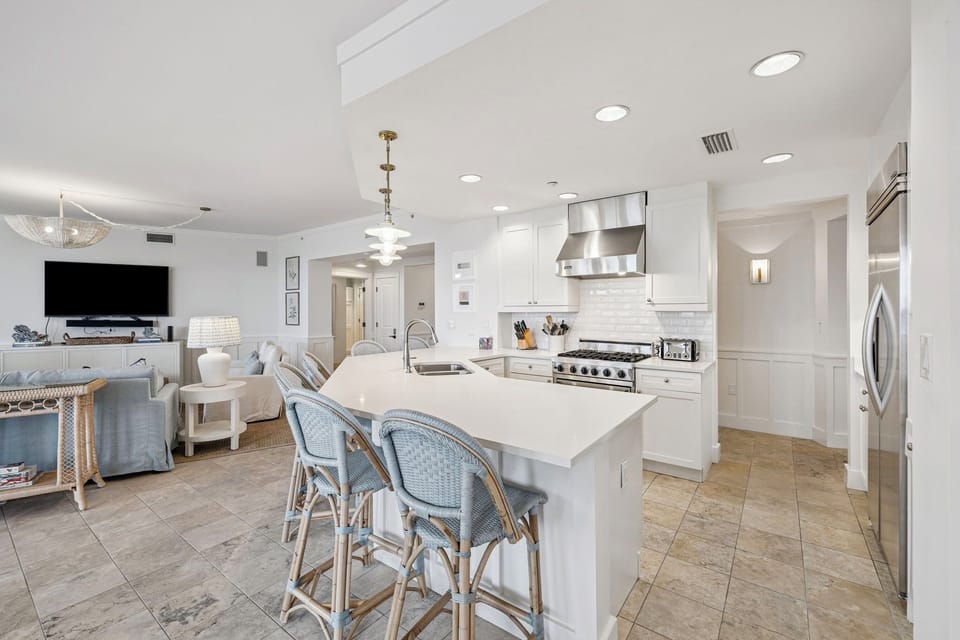 Your open-concept retreat blends coastal elegance with modern convenience—where gleaming counters, pro-grade appliances, and sun-drenched living spaces invite relaxed gatherings and gourmet moments.
