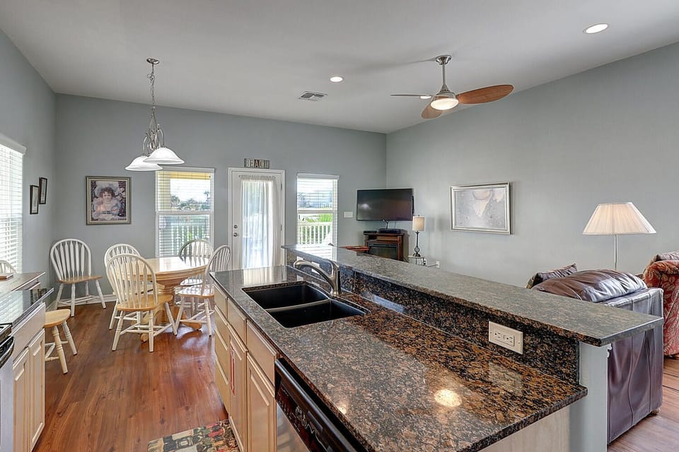 Step into your open-concept haven where granite countertops and hardwood floors create the perfect backdrop for memorable meals and cozy evenings together.