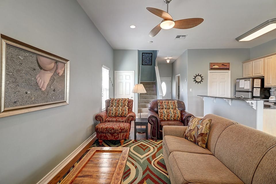 Unwind in your cozy living room with plush seating and coastal-inspired decor that creates the perfect retreat atmosphere.