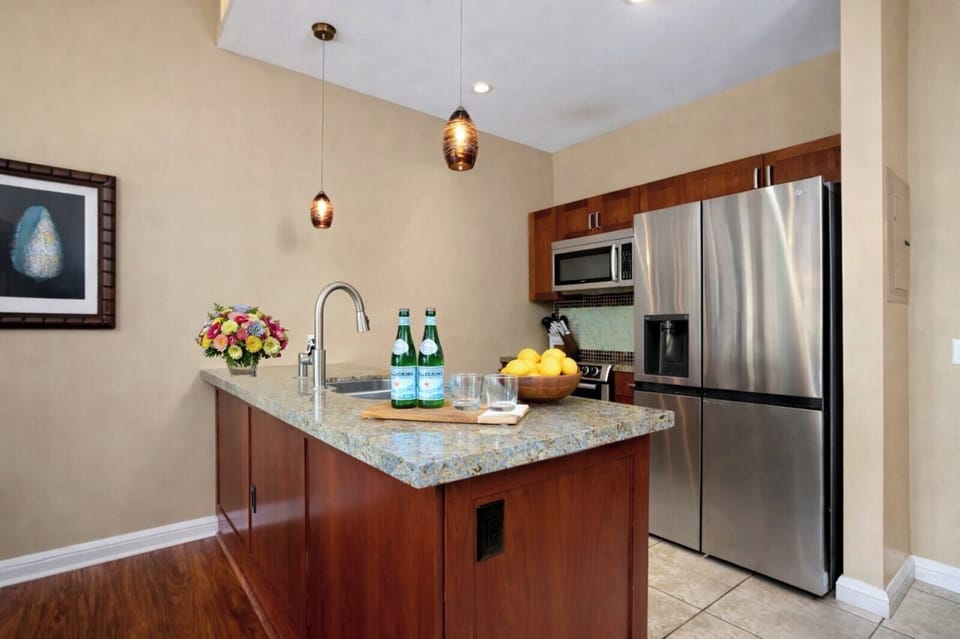 Prepare island inspired meals in your kitchen featuring granite counters and stainless steel appliances.