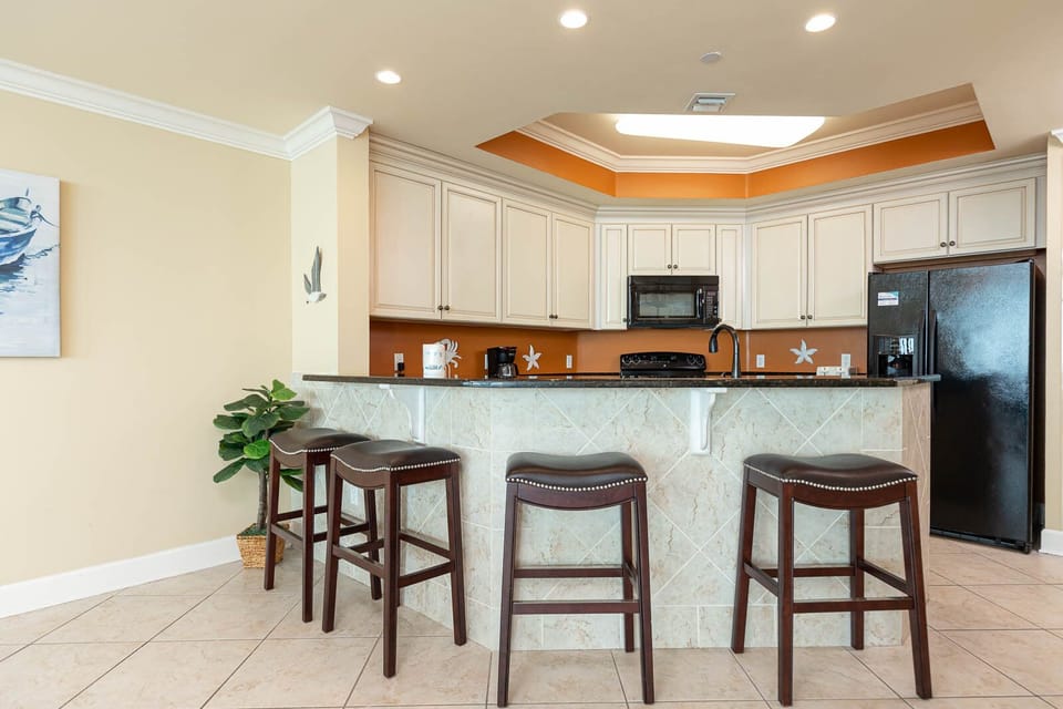 Sip your morning coffee at the breakfast bar and get ready for a beach day in this stylish space