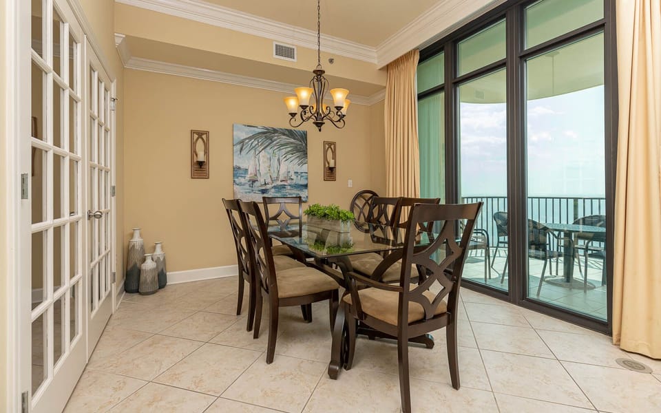 Savor family moments around the dining table, framed by expansive coastal views