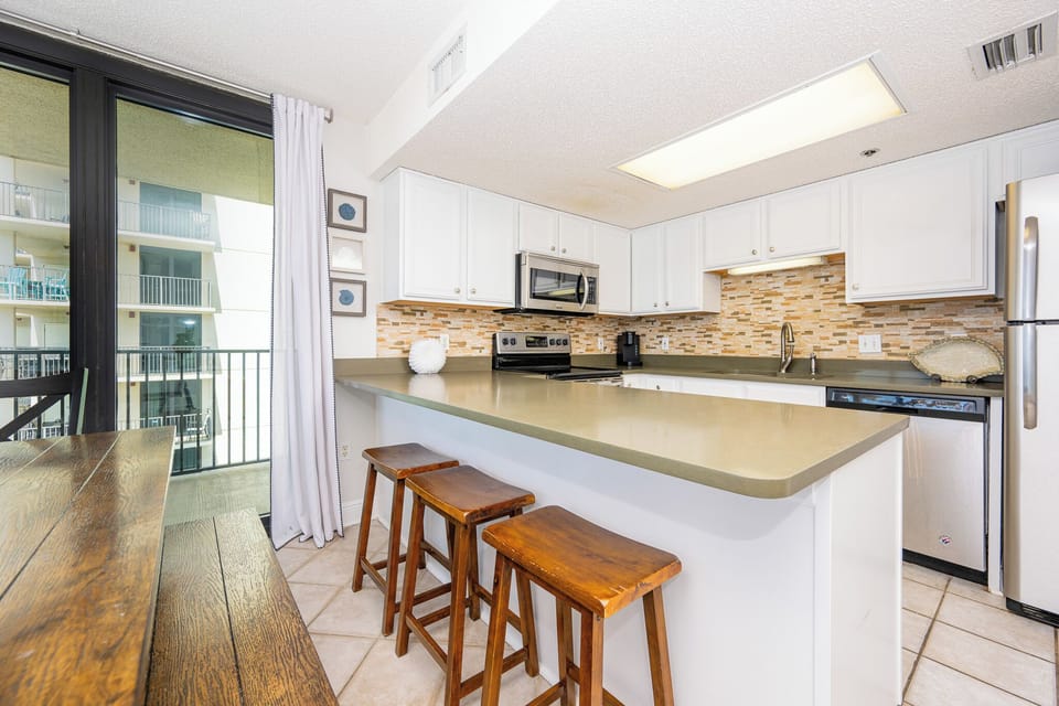 Enjoy preparing meals in the inviting kitchen with stainless appliances and a spacious breakfast bar for casual dining