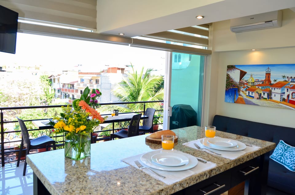 Kitchen, bar and living area opens completely to balconies for open-air living!