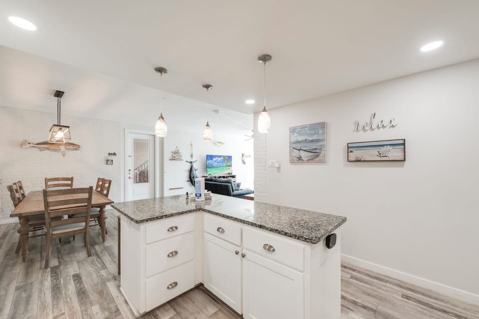 Your bright open kitchen flows seamlessly into the dining area, perfect for preparing meals and gathering with loved ones.
