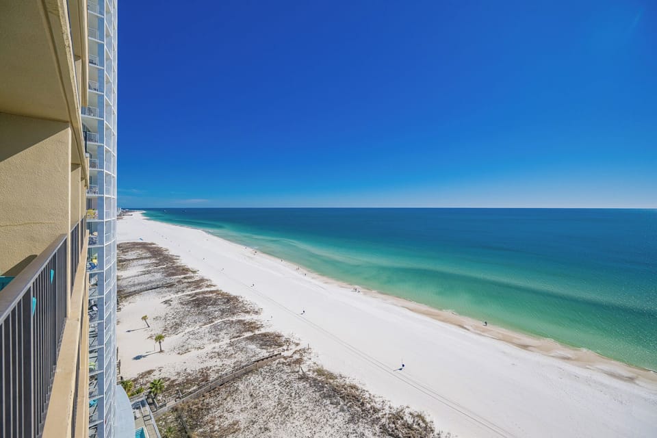 Tranquil, endless blue stretches across the coast as you savor peaceful moments from your balcony