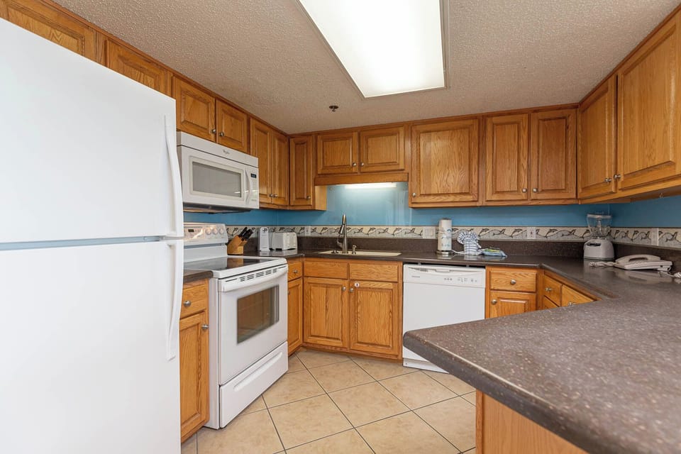 Warm amber tones embrace you as you prepare fresh meals in this cozy kitchen space