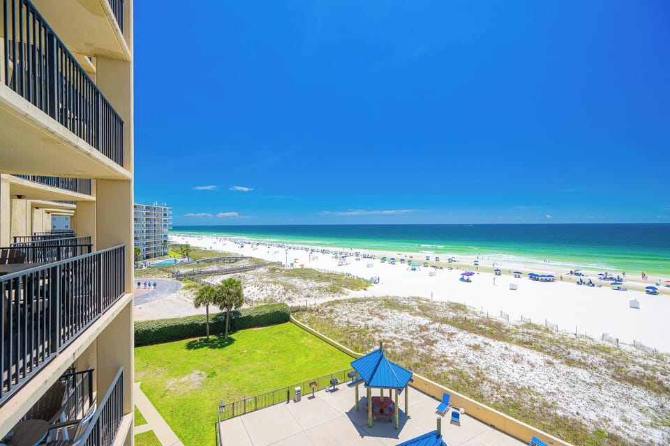Imagine afternoons spent watching kids play volleyball while the shore stretches wide beneath clear blue skies
