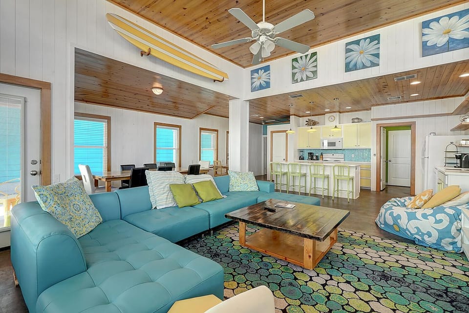 Relax in this bright open-plan space with stunning sea views through multiple windows and coastal-inspired décor throughout.